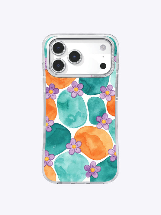 Clear iPhone 17 Pro Max case with overlapping teal and tangerine watercolor circles and small purple flowers