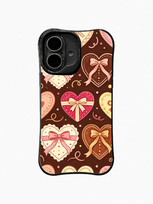 Dark brown iPhone 16 Plus case with pink and cream ribbon-wrapped hearts, bows, and curls