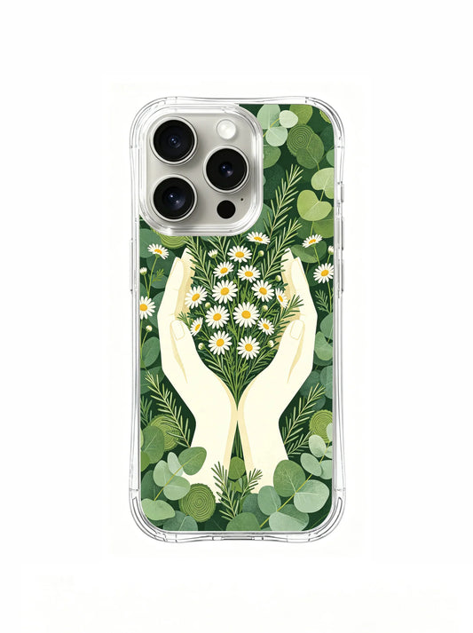 Clear iPhone 15 Pro case with two cream hands cupping a heart-shaped cluster of white daisies amid layered green leaves