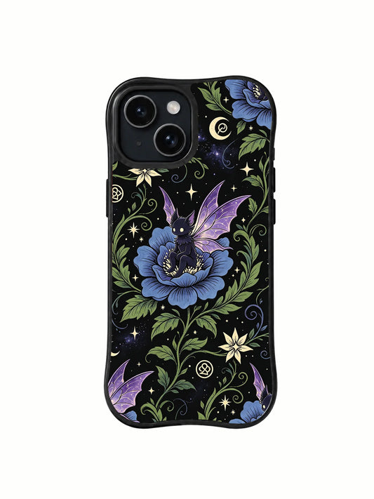 Black iPhone 15 Plus case with a large blue flower, purple winged figure, green vines, pale stars, crescent moons, and small geometric symbols