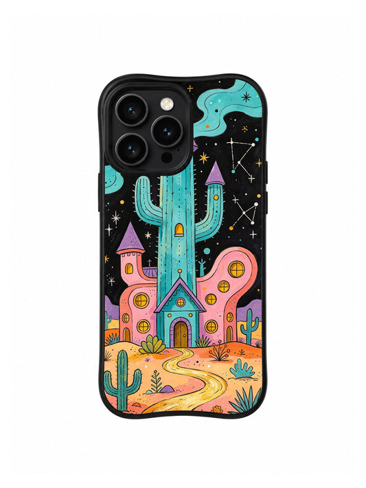 Dreaming Desert Observatory: A tall cactus tower above a pointed turquoise doorway, with a rounded pink building to the right.
