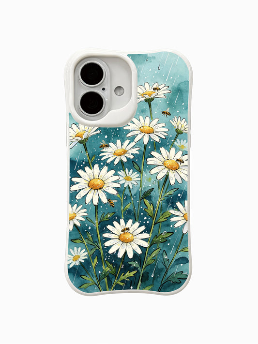 Mira Bloomwell’s whimsical Rainy Daisy Meadow design on this PhoneCasing iPhone 16 Plus Case, featuring dewy daisies and bees against a cool teal sky.
