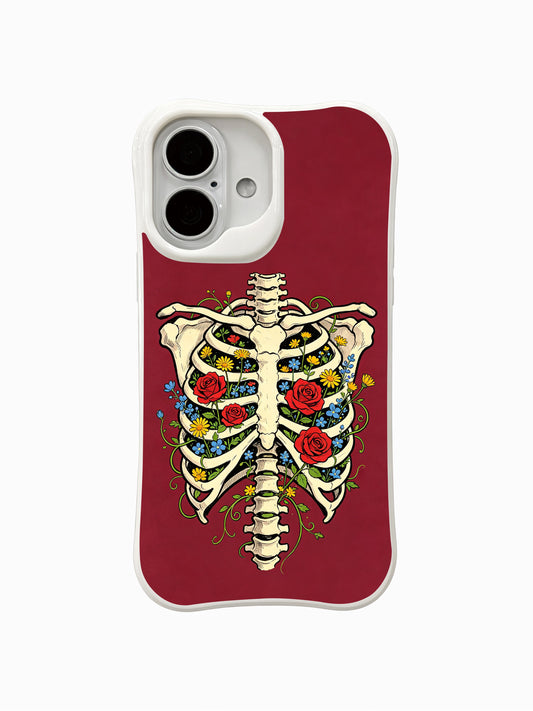 PhoneCasing Spring Inside Ribcage fine art iPhone 16 Case, vintage old-school tattoo goth artwork designed by Morrigan Vale, blooming red roses, yellow daisies and tiny blue wildflowers growing inside skeletal ribcage over burgundy red background