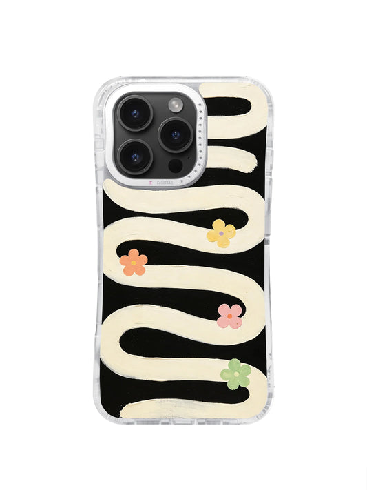 Cream wavy bands with small pastel flowers on a black iPhone 16 Pro Max case.