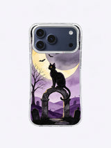 Golden-eyed black cat guarding a weathered arch under a butter-yellow crescent moon