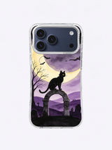Black cat sentinel with bats, bare tree, crescent moon and layered lavender cemetery hills