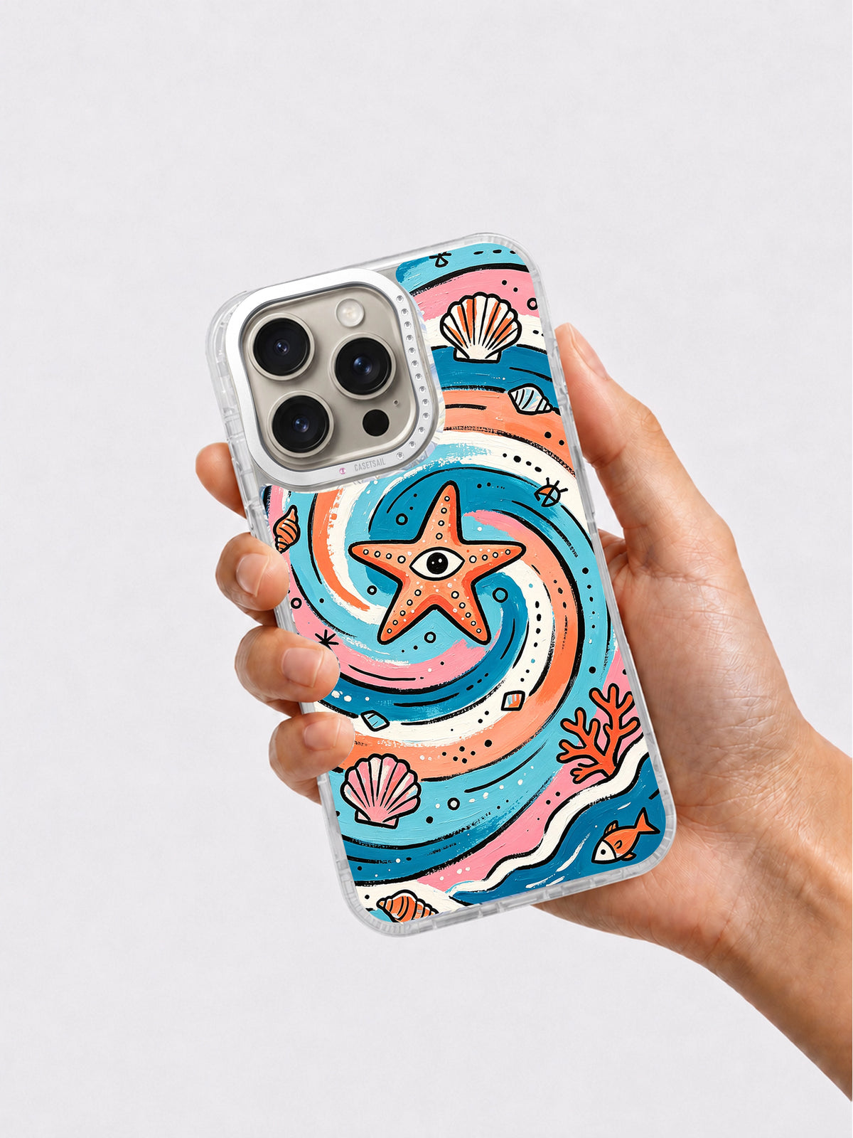 Hand holding colorful starfish and seashell iPhone case