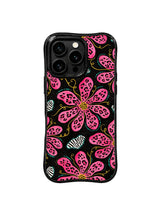 PhoneCasing iPhone 15 pro max cover in bright natural light, showing saturated hot pink and deep black pop art color, bold statement phone case.