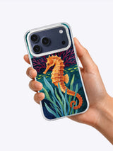Hand holding a clear iPhone case printed with Amber Seahorse Reef art