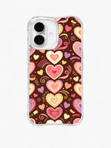 Frosted Heart Confetti: Layered pink, cream and red hearts form a central column with small ribbons on brown.