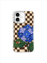 Snail's Slow Arrival iPhone 17 case artwork with a tiny snail below a blue hydrangea cluster on a brown-and-cream checkerboard.