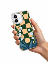 Hand holding the lily of the valley checkerboard iPhone 17 case