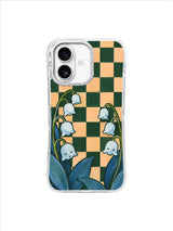 Cool blue leaves and pendant lily bells against dark green and peach checks
