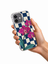 Hand holding the magenta orchid checkerboard iPhone 17 case