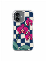Aesthetic floral iPhone 17 case with magenta orchids and bowed checkerboard lines
