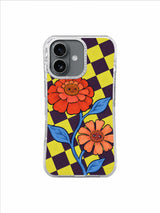 Warm orange red and peach zinnias against diagonal purple yellow checks