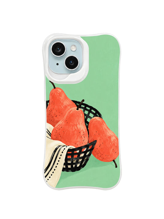 Coral pears in a tilted black basket with a cream towel on mint green