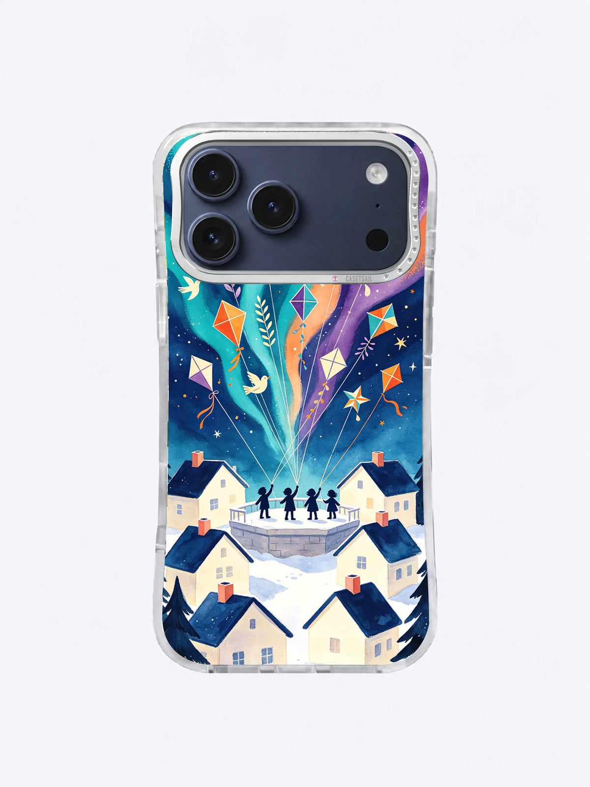 Teal and orange bird kites over cream village rooftops on an iPhone 17 Pro Max case