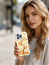 Autumn Candy Forest iPhone 14 Pro case held in hand
