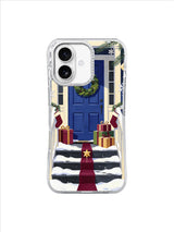 Cobalt blue Christmas door with evergreen wreath, gifts, and burgundy ribbon on an iPhone 17 case
