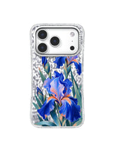Shared Ascent pattern with a large cobalt iris, smaller upper blooms, coral accents, and deep teal foliage on an iPhone 17 Pro case