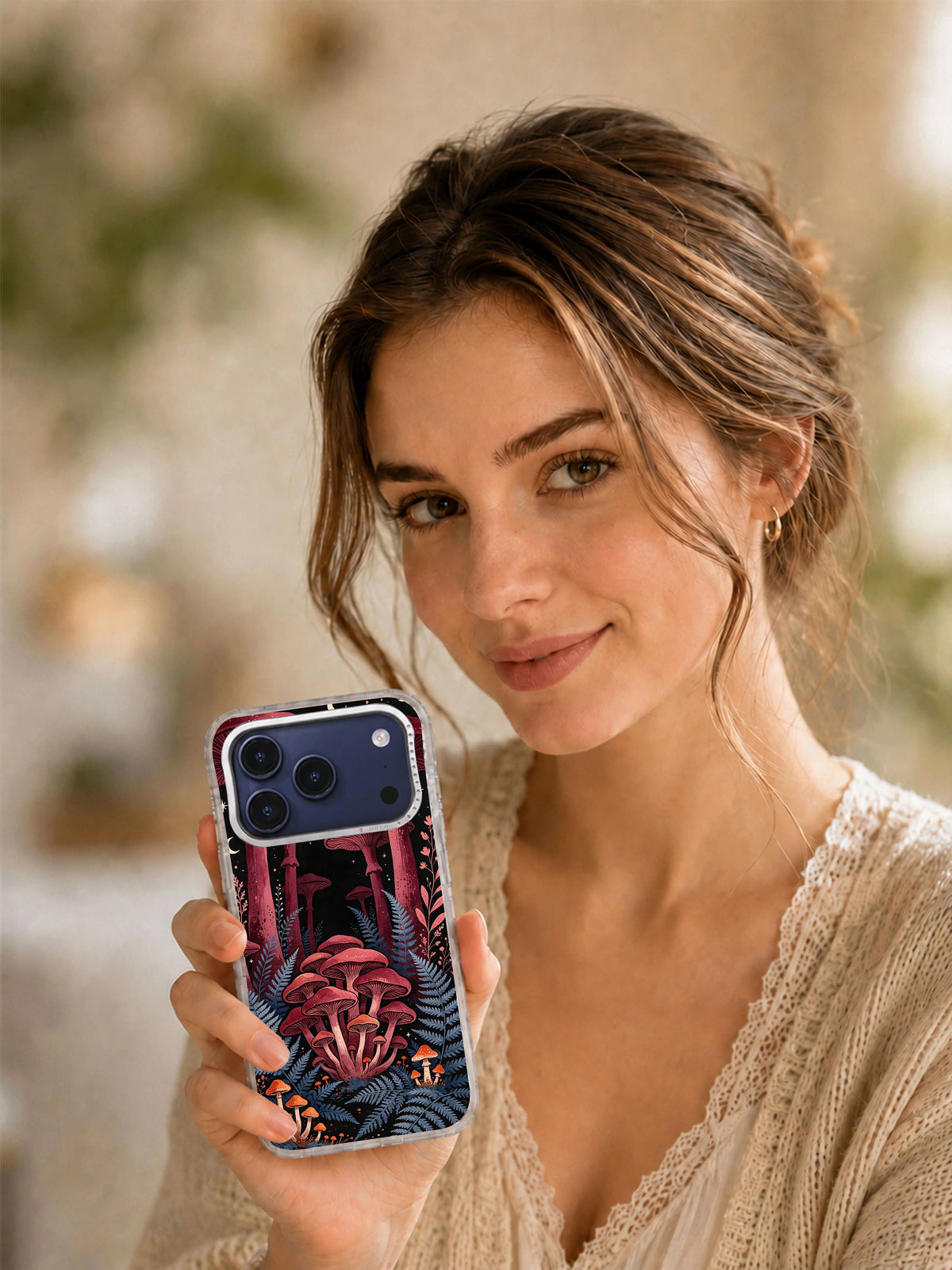 Lifestyle portrait with a phone case featuring the Burgundy Mushroom Cathedral night-forest artwork
