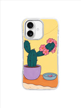 Pink flower collar circling a teal cactus above coral cloth and a pale water dish
