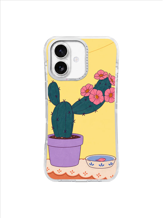 Deep petrol cactus wearing a crownlike collar of pink flowers above a lilac pot