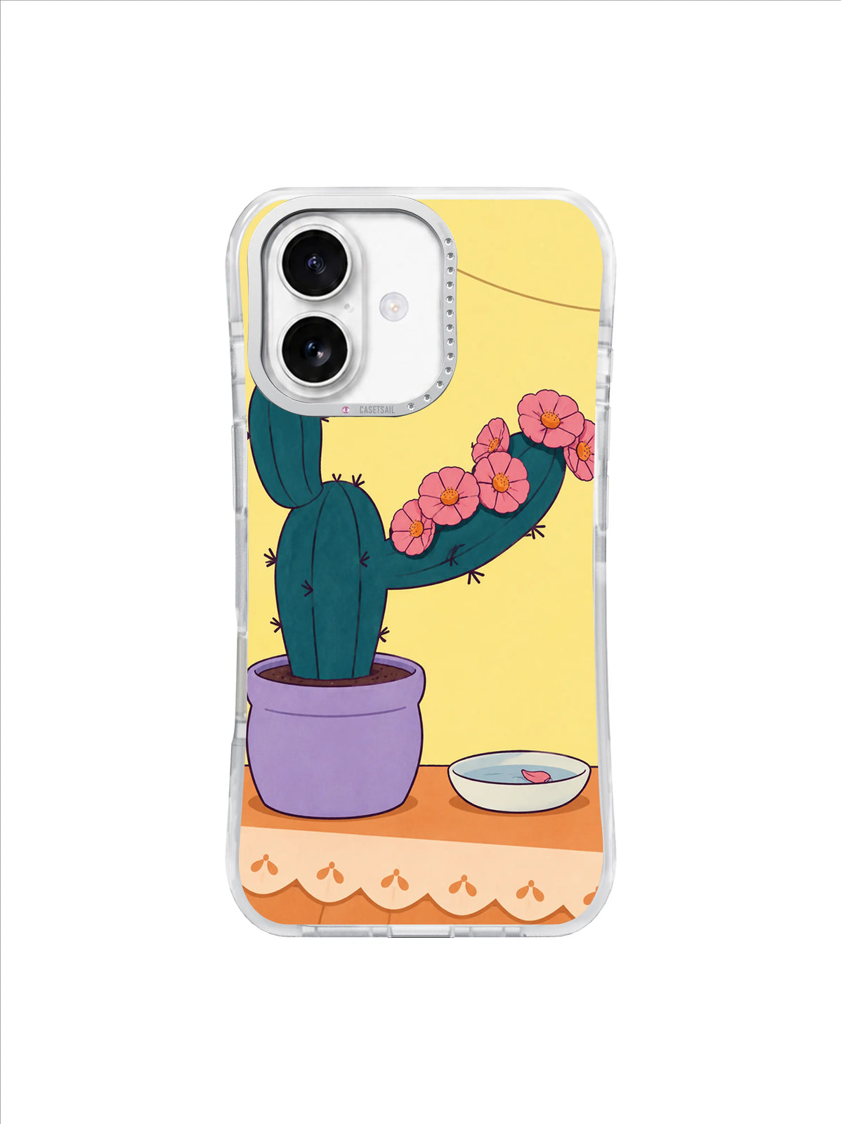 Teal cactus with a loose rose-pink flower collar above a scalloped cream cloth edge