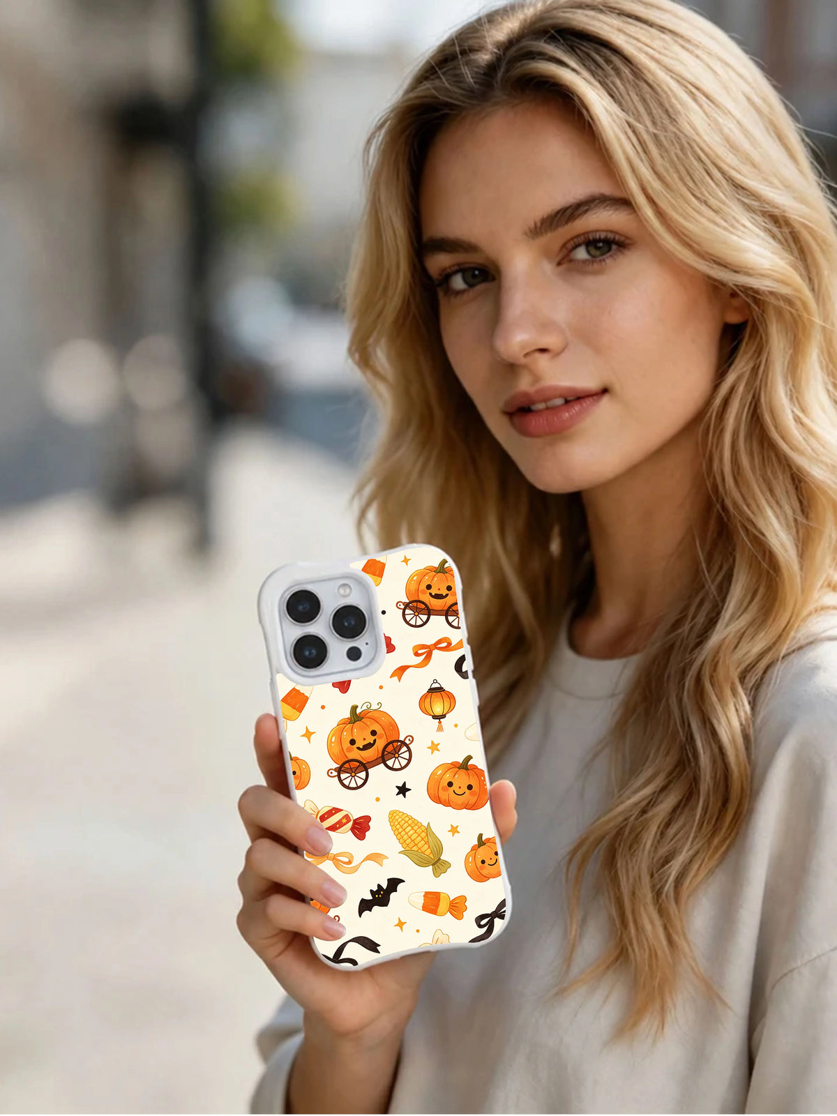 Candy Corn Lantern Waltz iPhone 14 Pro case held in hand