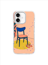 Empty teal chair, coral dance shoes, and lavender confetti on peach