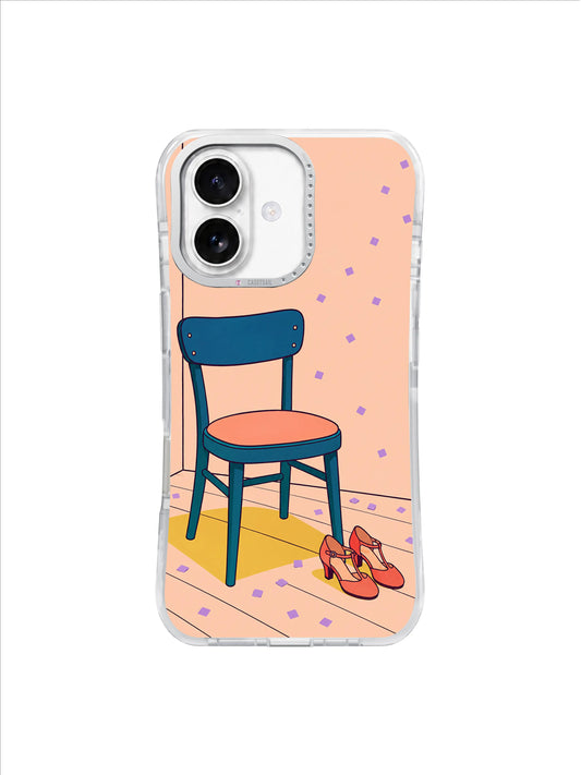 Deep teal chair and coral dance shoes resting on a peach floor with lavender confetti