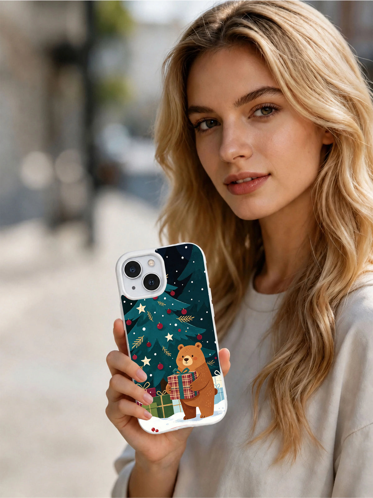 Person holding the Christmas Bear and Gift Tree iPhone 14 case