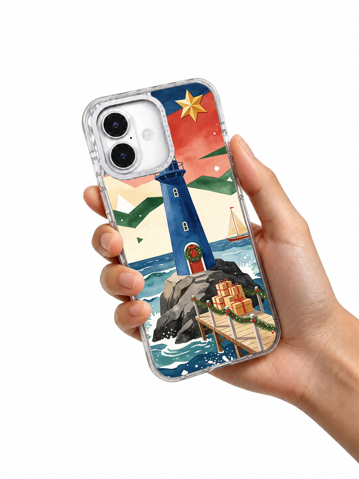 Christmas at the Blue Lighthouse iPhone 17 case shown in hand