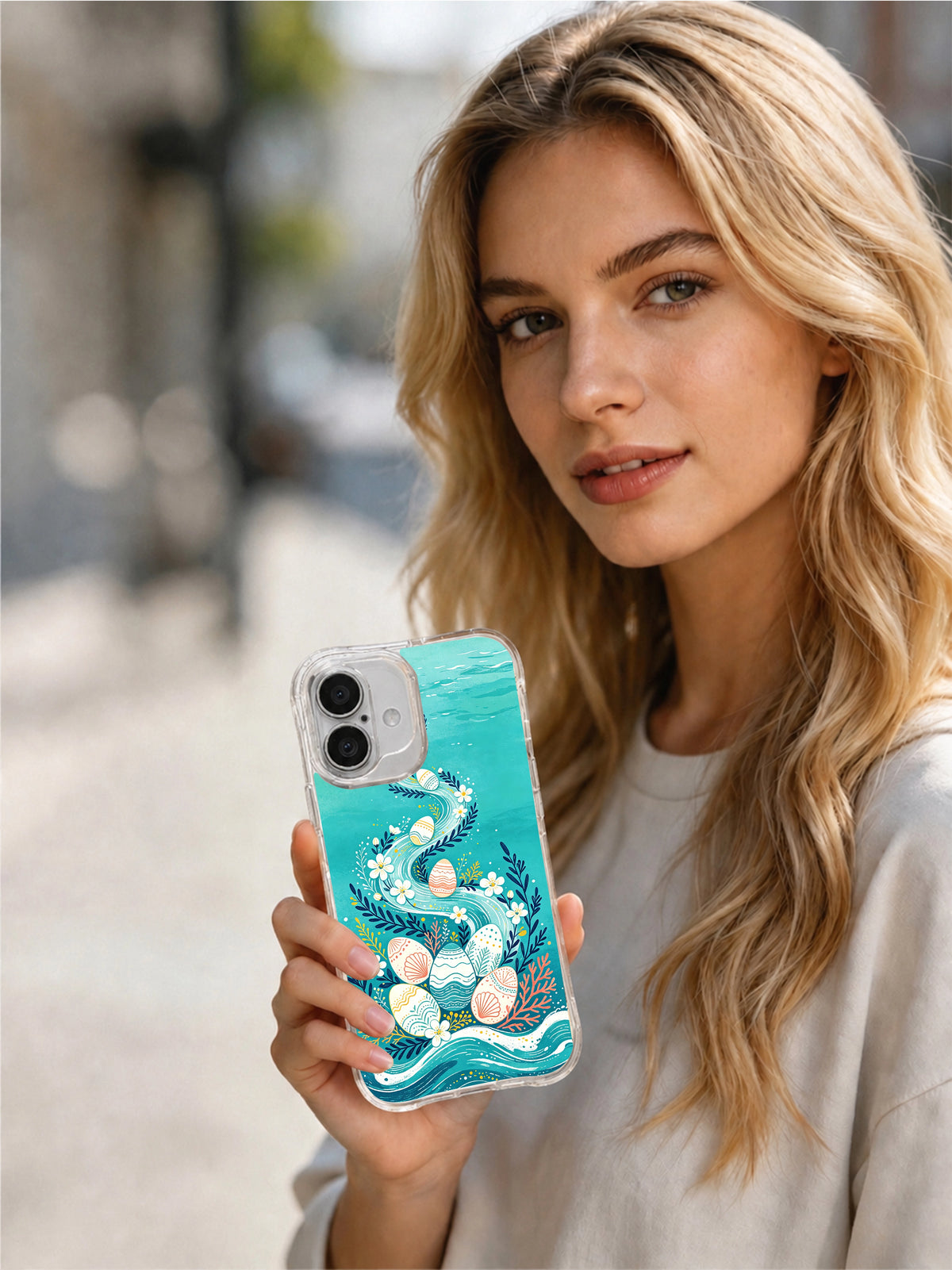 Coastal Egg Parade: A person holding the illustrated case outdoors.