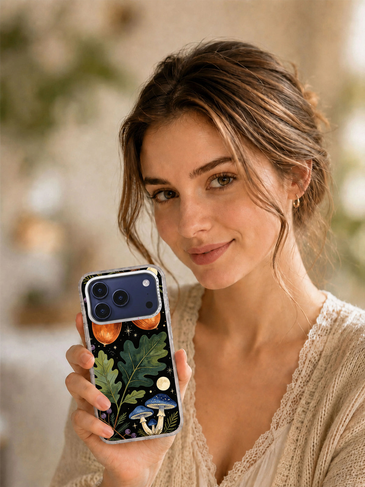 Lifestyle portrait with a phone case featuring the Copper Acorn Moon Grove woodland artwork