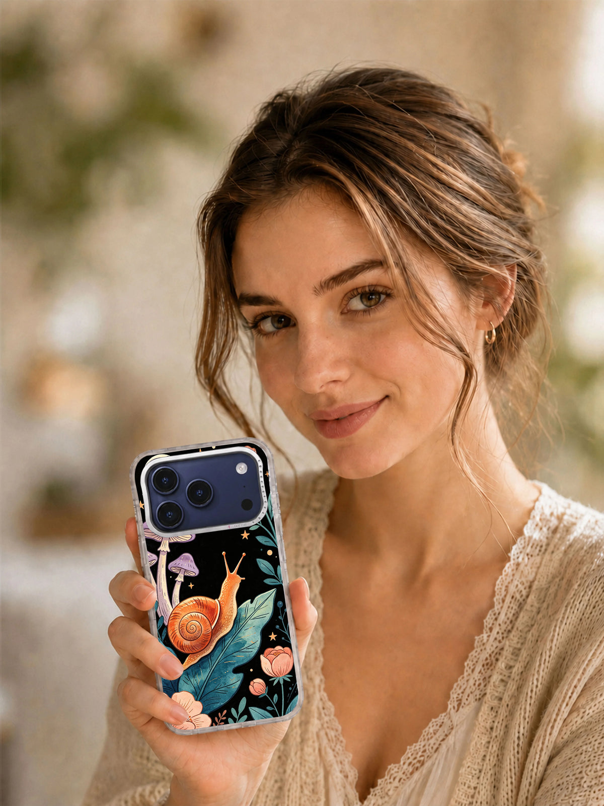 Lifestyle view of Coral Snail Moon Garden iPhone case with cottagecore artwork