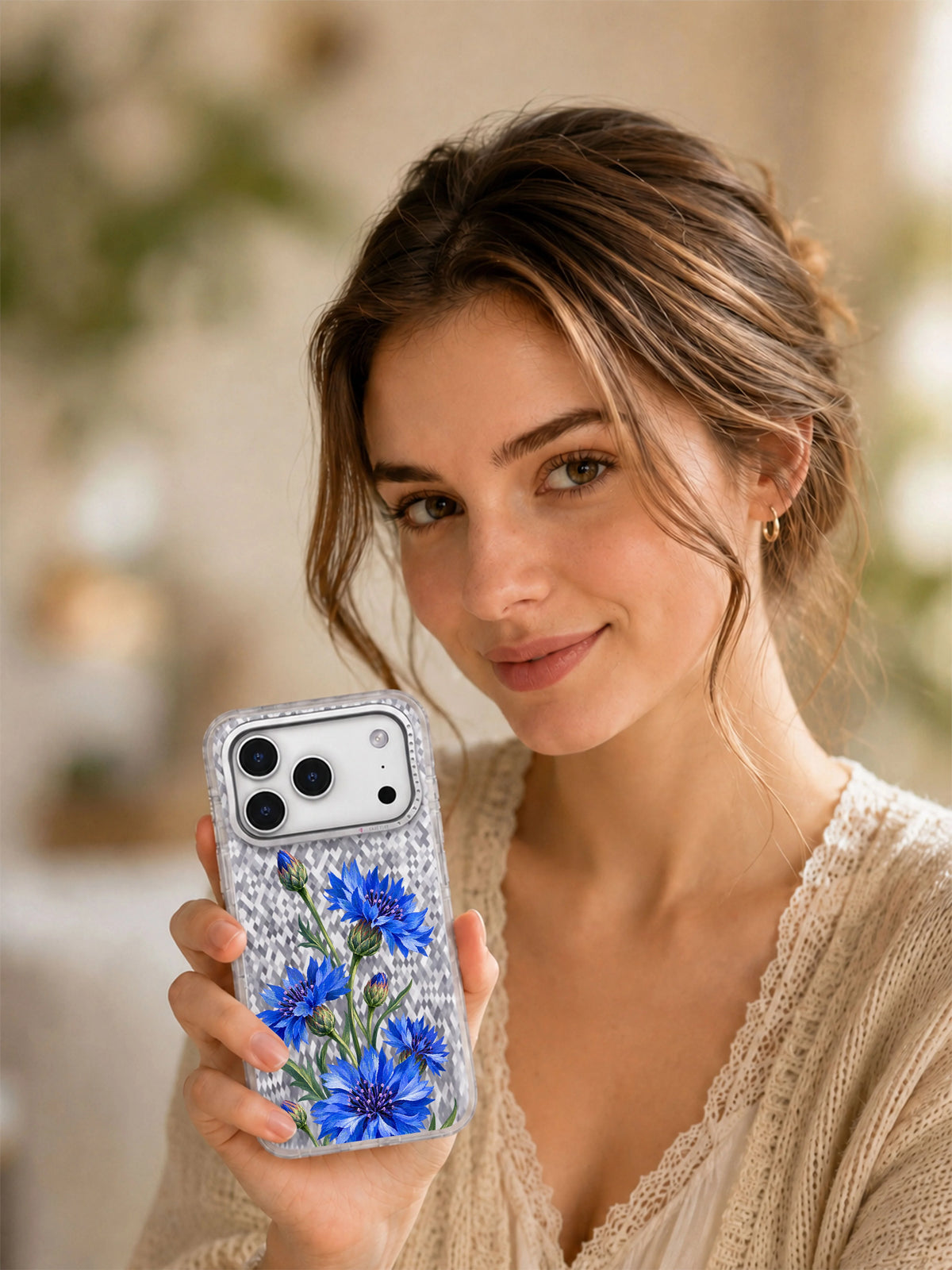 Lifestyle view of a woman holding the Cornflower Zigzag transparent iPhone 17 Pro case