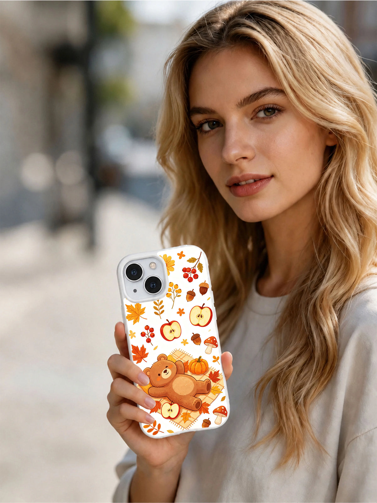 Cozy Bear Harvest Picnic: Person holding the illustrated case outdoors.