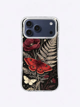 Large red moth among poppies, pale ferns, blackberry branches, and ivory moths on charcoal black
