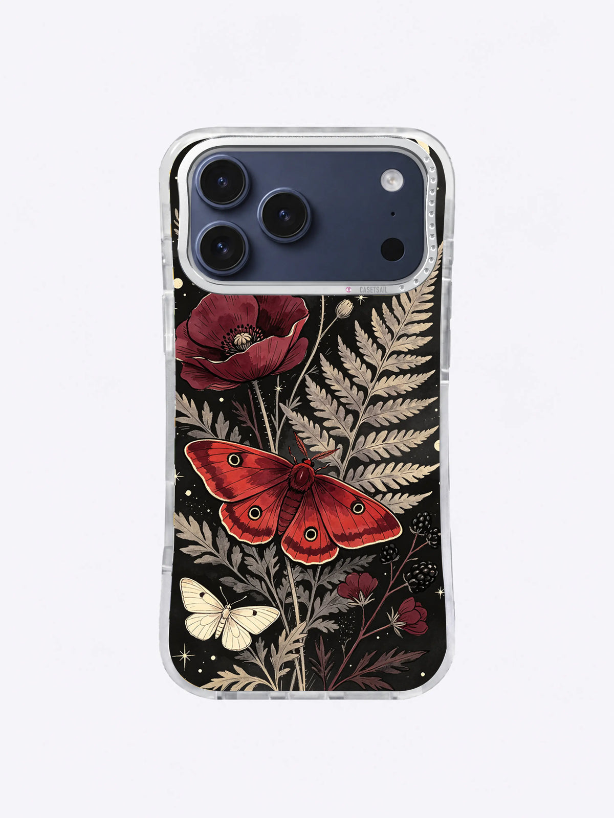 Large red moth among poppies, pale ferns, blackberry branches, and ivory moths on charcoal black