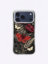 Dark botanical moth case art with crimson wings, cream moths, red flowers, berries, and moon details