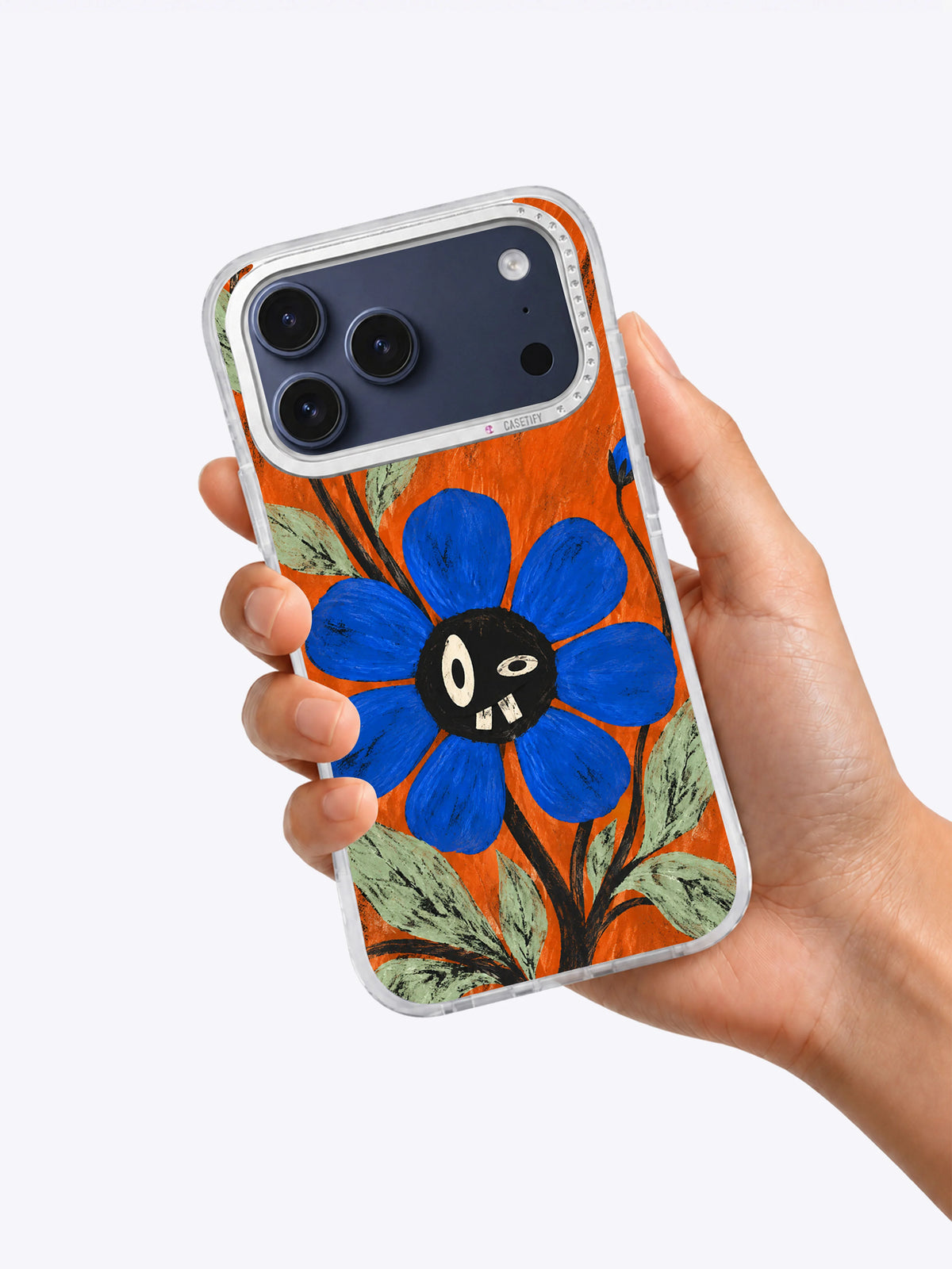 A Bloom with Crooked Teeth iPhone 17 Pro Max case held in hand