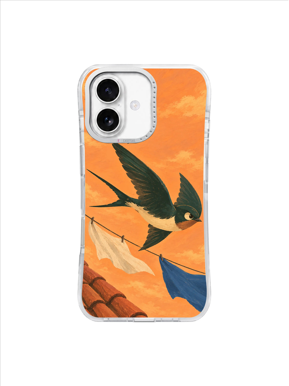 Three bottle-green swallows banking through a peach-orange sky above roof tiles on an iPhone 17 case
