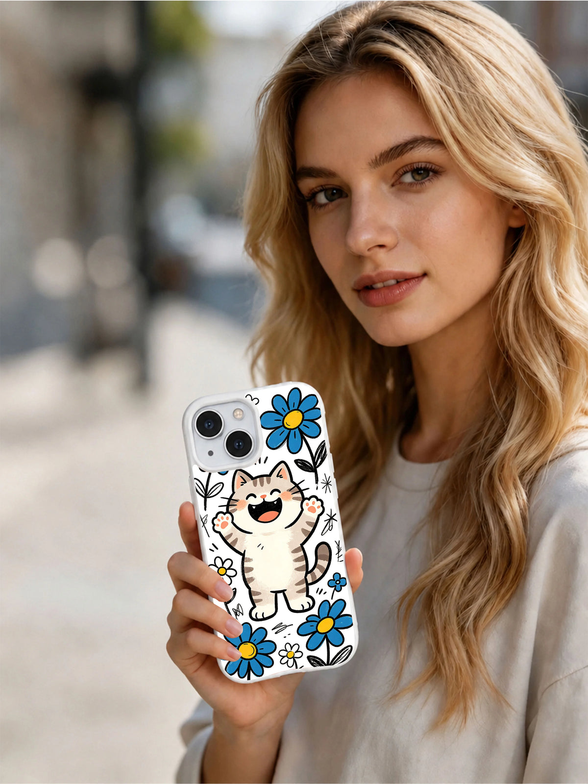 Lifestyle view of a woman holding the Daisy Cat Parade iPhone 13 case
