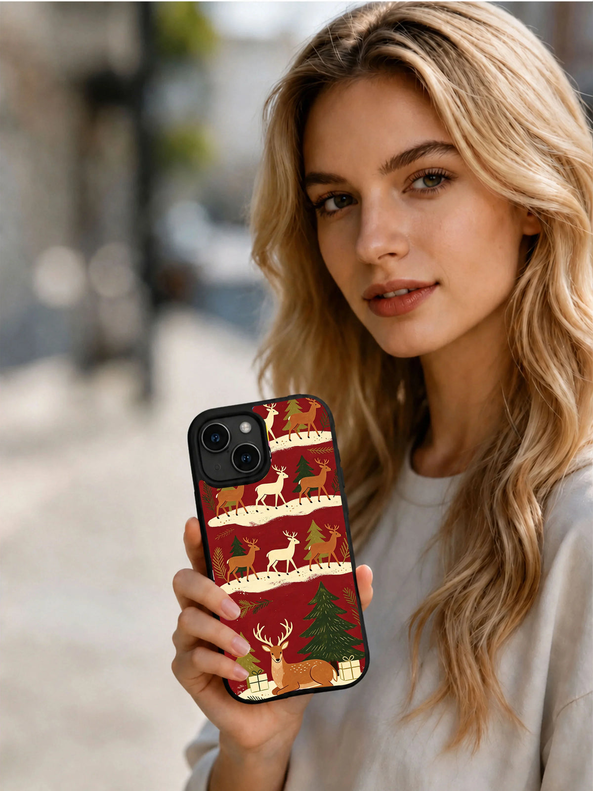 Woman holding the Deer Through December iPhone 15 case