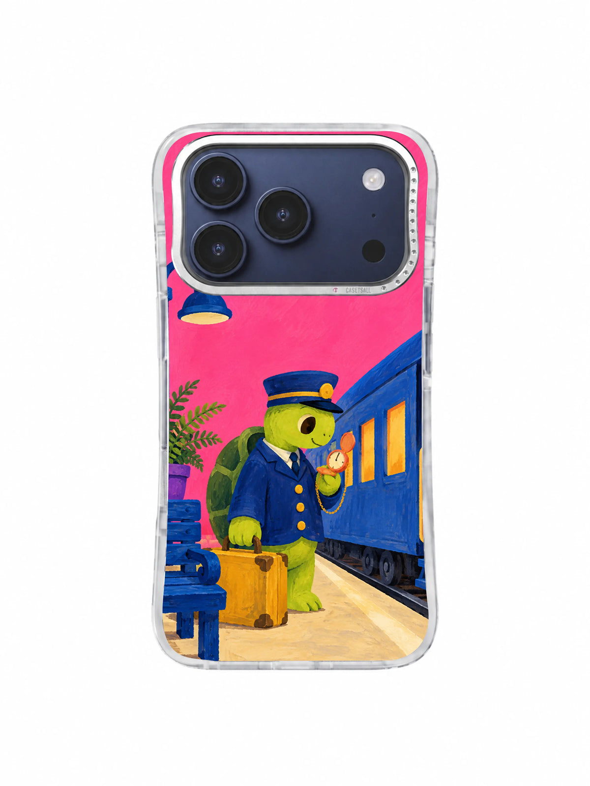 Turtle conductor checking the cream platform line and mustard suitcase on an iPhone 17 Pro case