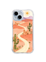 Adobe Cactus Trail: A white road crosses peach desert slopes between adobe buildings and green cacti.