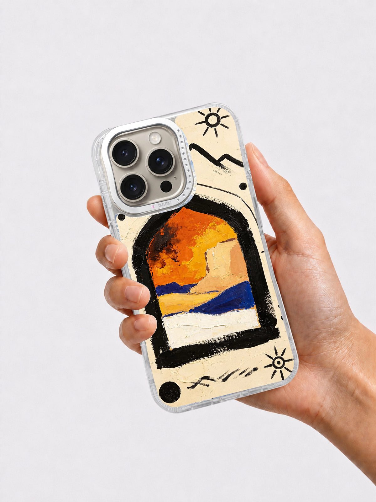 Hand holding painted desert iPhone 16 Pro case