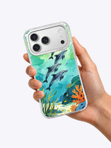 Dolphins After Rain coastal art iPhone case held in hand